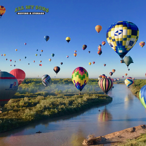 several hot air balloons over a river in albuquerque