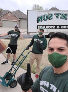 three guys with green medical masks over mouths