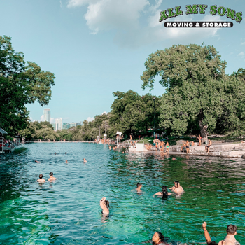 people swimming in the barton springs pool in austin, texas