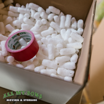 a box filled with packing peanuts and a roll of tape.