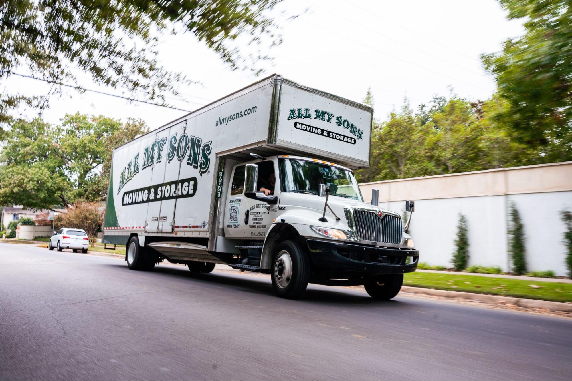 All My Sons moving truck drives through a neighborhood to complete a local move.