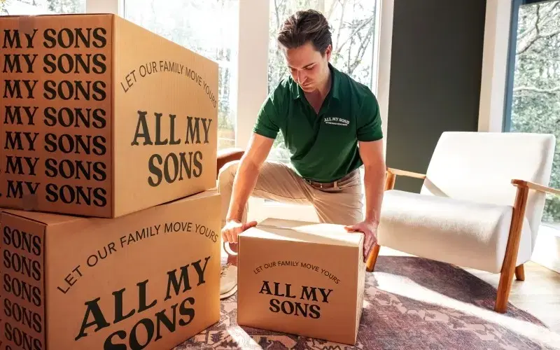Local mover picks up an All My Sons Moving and Storage branded box.