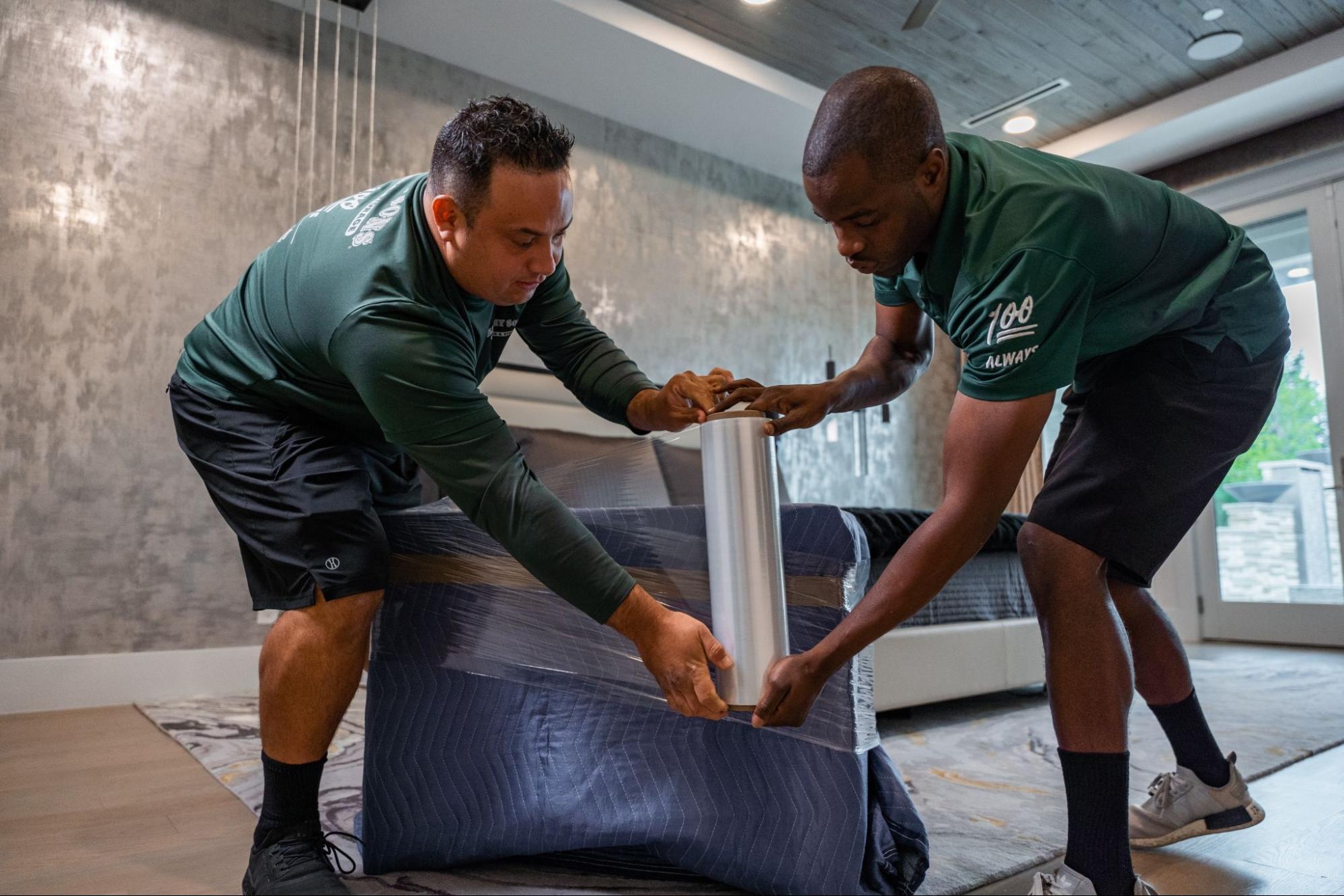 All My Sons professional movers wrap a couch to protect it during transportation.